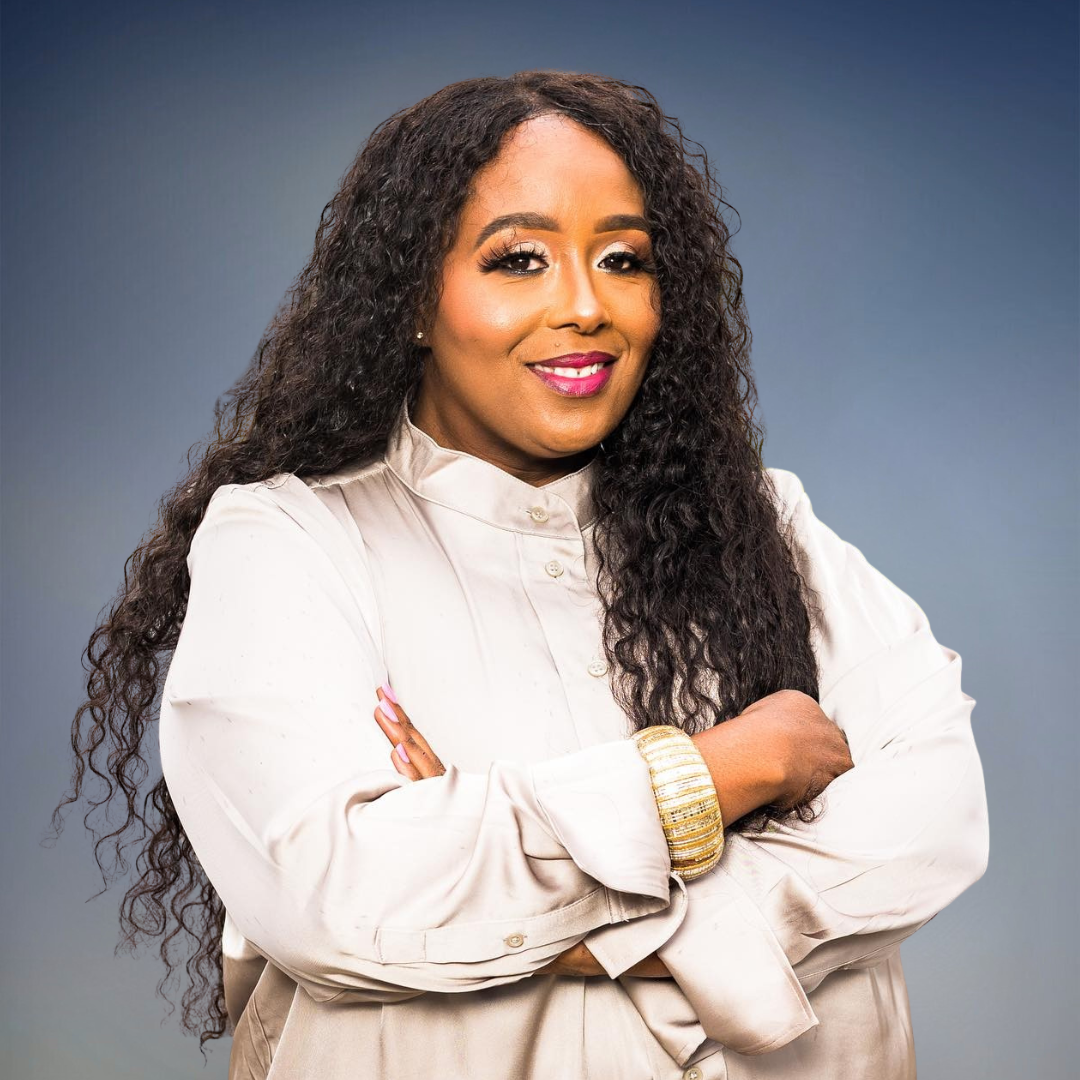 Shauna Smith, business development and marketing specialist, smiling with arms crossed in a cream blouse