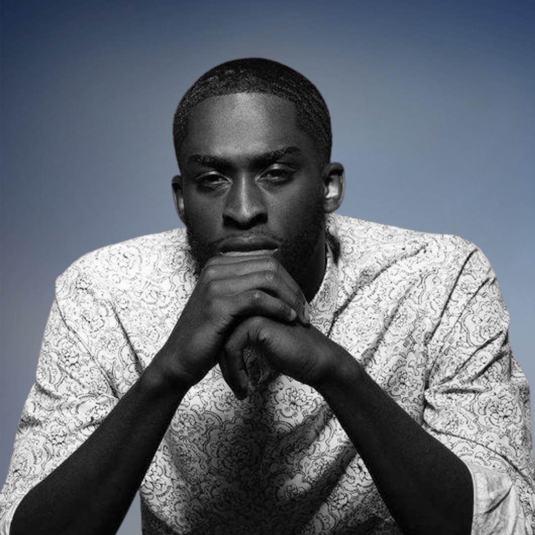 Darian Marson, Account Executive at Common Walk, wearing a patterned shirt with hands clasped