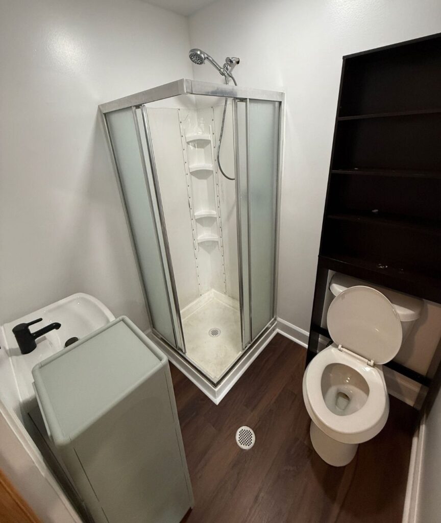 Bathroom with corner shower and toilet at 4843 Old Dixie Highway Forest Park GA rental unit