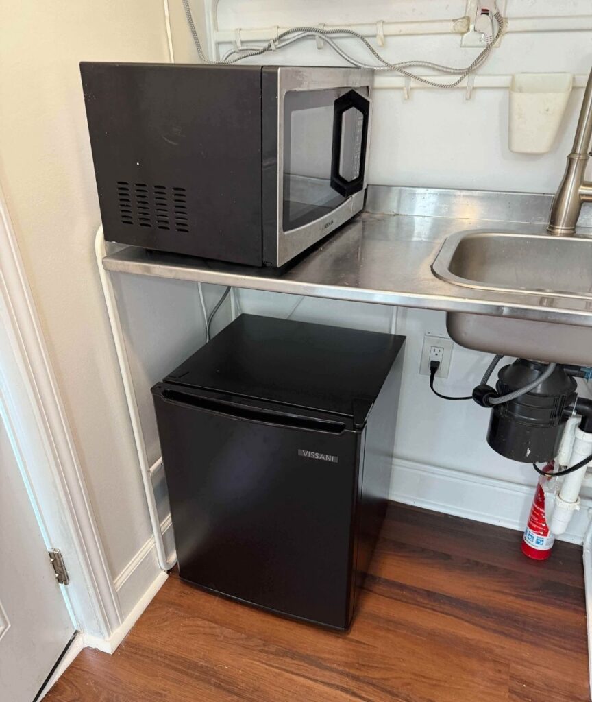 Kitchenette with microwave and mini fridge at 4843 Old Dixie Highway Forest Park GA rental project